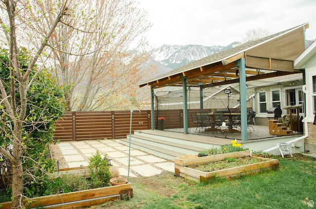 1849 E Gracey Ln S, Sandy, UT 84092 - view of patio with fence, a garden, and a mountain view