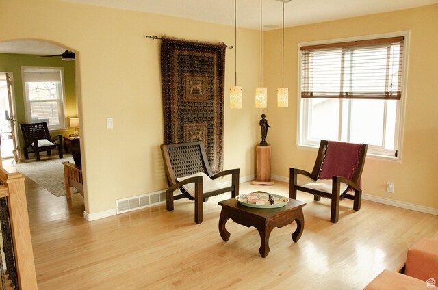 1849 E Gracey Ln S, Sandy, UT 84092 - sitting room with arched walkways, light wood-style floors, visible vents, and baseboards