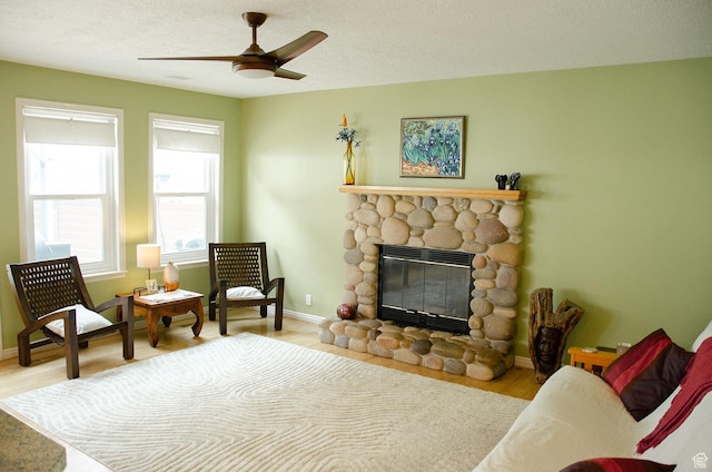 1849 E Gracey Ln S, Sandy, UT 84092 - sitting room with baseboards, a ceiling fan, wood finished floors, and a stone fireplace