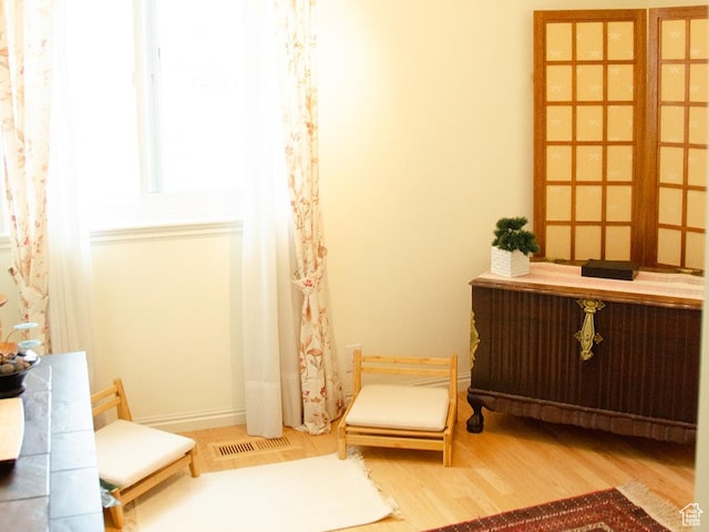 1849 E Gracey Ln S, Sandy, UT 84092 - sitting room with radiator heating unit, wood finished floors, visible vents, and baseboards
