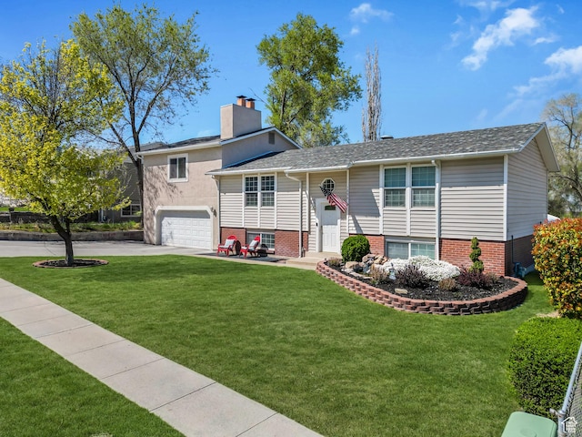 bi-level home with a chimney, an attached garage, concrete driveway, and a front yard
