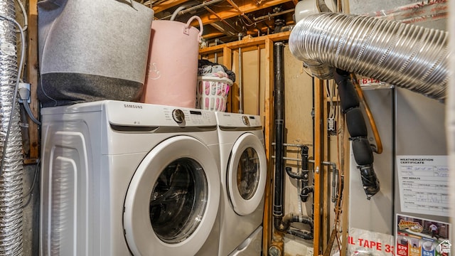 clothes washing area featuring washing machine and clothes dryer and laundry area