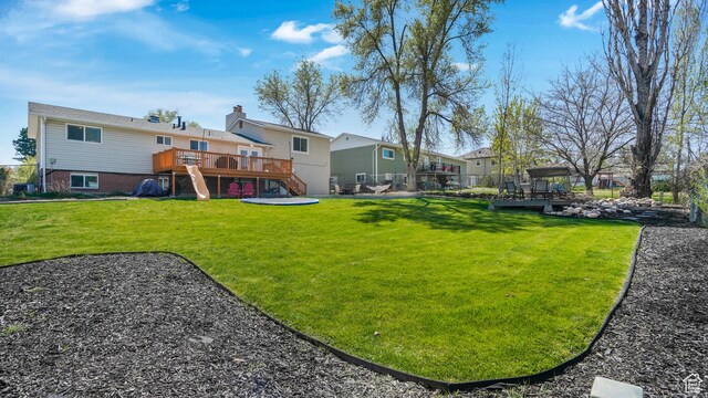 view of yard with stairs and a deck