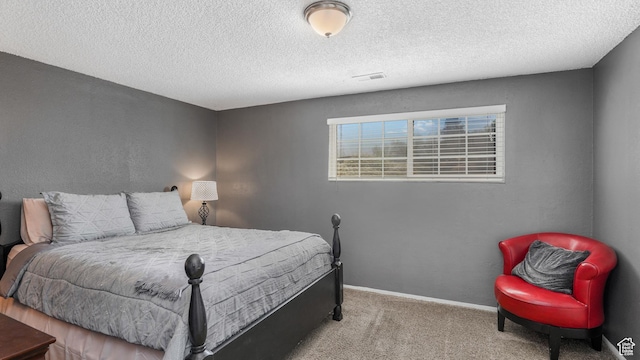 carpeted bedroom with baseboards, a textured ceiling, and visible vents