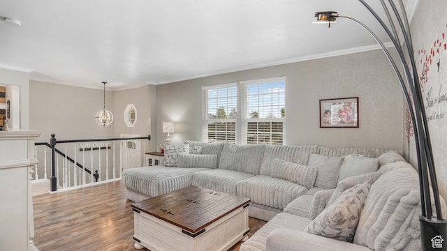 living room with wood finished floors and ornamental molding