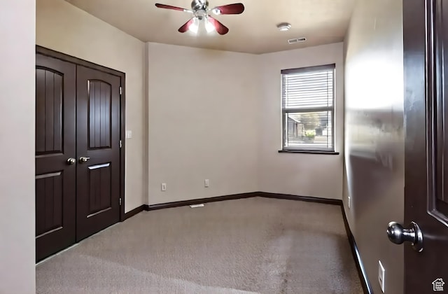 5095 N Ridgeview Cir, Enoch, UT 84721 - unfurnished bedroom with carpet, visible vents, a closet, baseboards, and ceiling fan