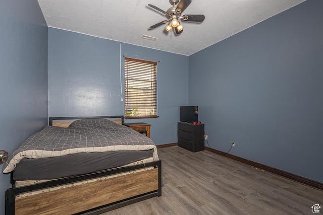 5095 N Ridgeview Cir, Enoch, UT 84721 - bedroom with wood finished floors, visible vents, baseboards, a textured ceiling, and ceiling fan