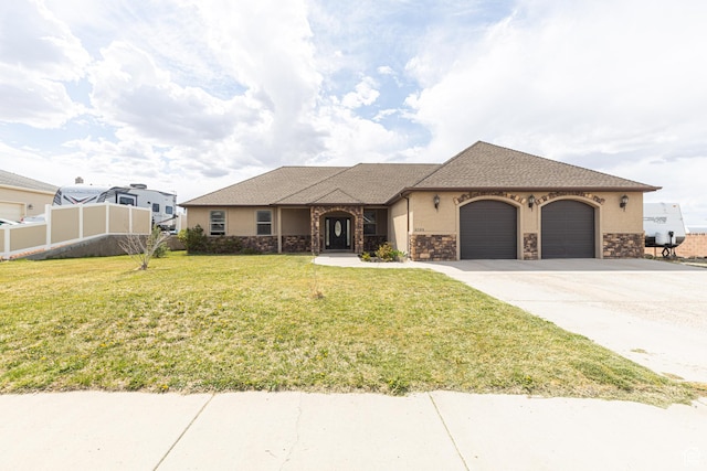 5095 N Ridgeview Cir, Enoch, UT 84721 - ranch-style house with a front lawn, concrete driveway, fence, a garage, and stucco siding
