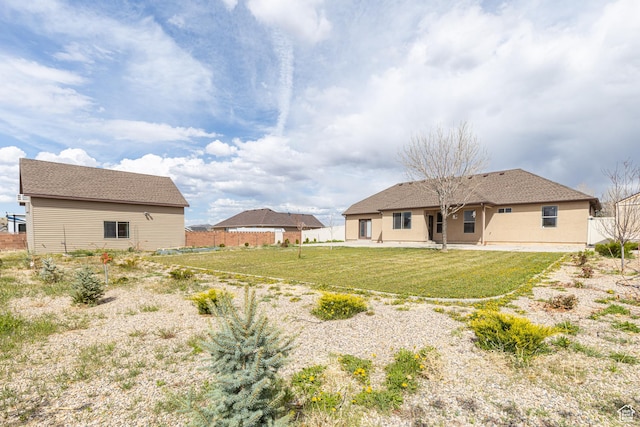 5095 N Ridgeview Cir, Enoch, UT 84721 - rear view of house featuring a lawn and fence