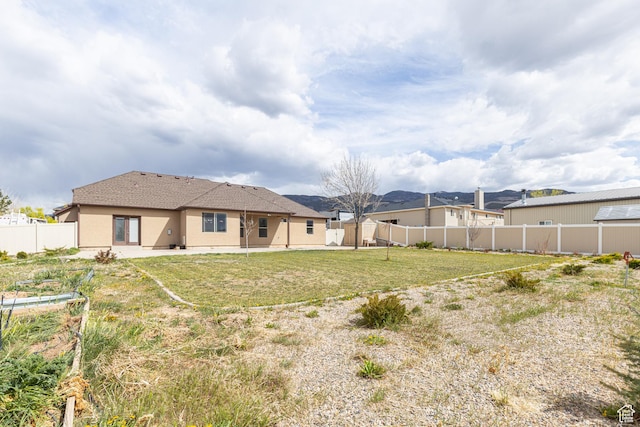 5095 N Ridgeview Cir, Enoch, UT 84721 - rear view of house with a yard, fence, a patio area, and stucco siding