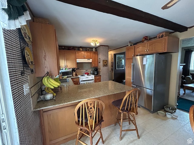 3748 W 5140 S, Taylorsville, UT 84129 - kitchen featuring light stone counters, under cabinet range hood, freestanding refrigerator, white range with electric cooktop, and a peninsula