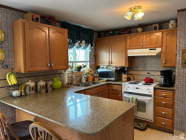 3748 W 5140 S, Taylorsville, UT 84129 - kitchen featuring a sink, stainless steel microwave, a peninsula, under cabinet range hood, and white electric stove