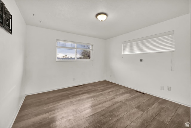 empty room with visible vents and wood finished floors