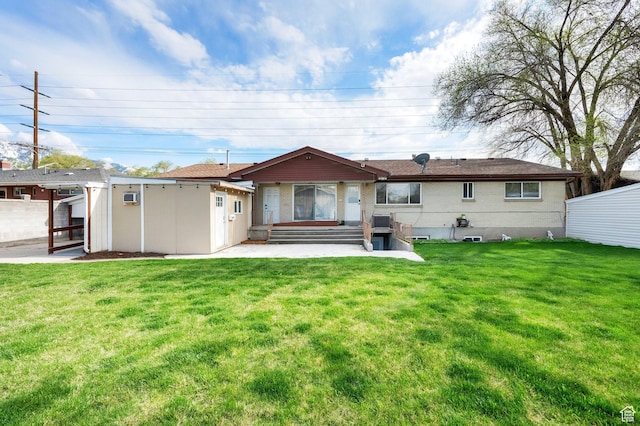 back of house featuring a patio area, entry steps, and a yard