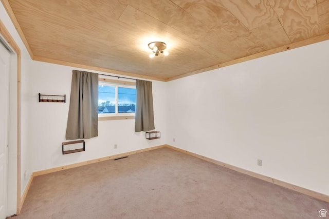 unfurnished room with baseboards, visible vents, and carpet floors