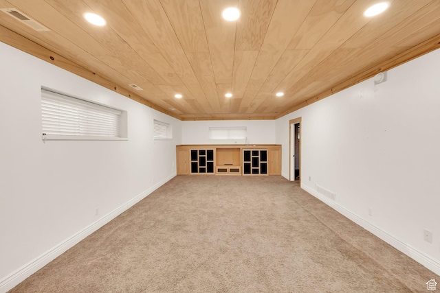 finished basement with wood ceiling, carpet flooring, visible vents, and recessed lighting