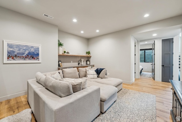 11431 N Ursa Cir Unit 56, Heber City, UT 84032 - living area with recessed lighting, light wood-style floors, bar area, and baseboards