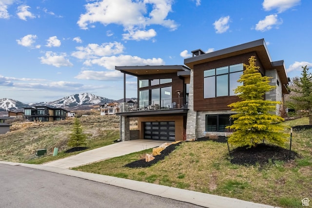 11431 N Ursa Cir Unit 56, Heber City, UT 84032 - contemporary home with a balcony, concrete driveway, a front yard, a mountain view, and a garage