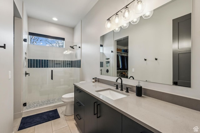 11431 N Ursa Cir Unit 56, Heber City, UT 84032 - bathroom featuring tile patterned floors, toilet, a stall shower, a spacious closet, and vanity