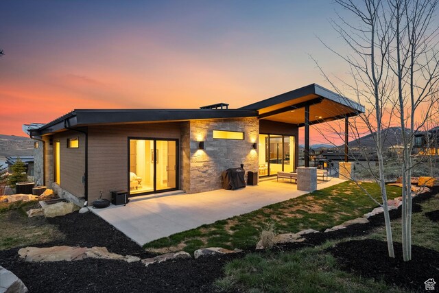 11431 N Ursa Cir Unit 56, Heber City, UT 84032 - back of property at dusk featuring a lawn and a patio area