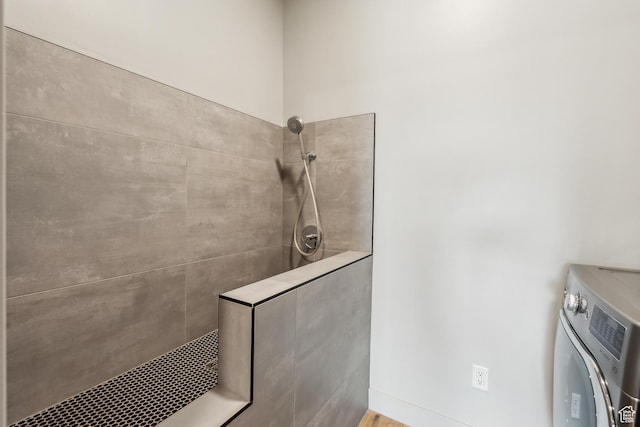 11431 N Ursa Cir Unit 56, Heber City, UT 84032 - bathroom featuring a tile shower and washer / clothes dryer