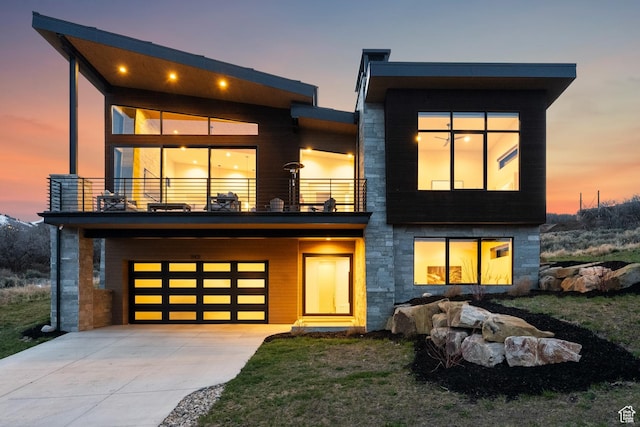 11431 N Ursa Cir Unit 56, Heber City, UT 84032 - view of front of house featuring a garage, stone siding, concrete driveway, and a balcony