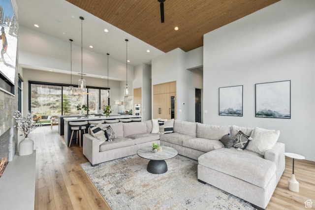 11431 N Ursa Cir Unit 56, Heber City, UT 84032 - living room with recessed lighting, a towering ceiling, light wood-type flooring, wood ceiling, and a fireplace