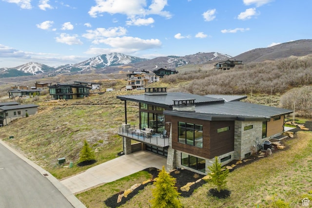 11431 N Ursa Cir Unit 56, Heber City, UT 84032 - exterior space featuring a standing seam roof, a carport, a mountain view, driveway, and metal roof