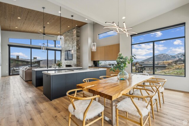 11431 N Ursa Cir Unit 56, Heber City, UT 84032 - dining space featuring a mountain view, light wood-type flooring, recessed lighting, a chandelier, and a high ceiling