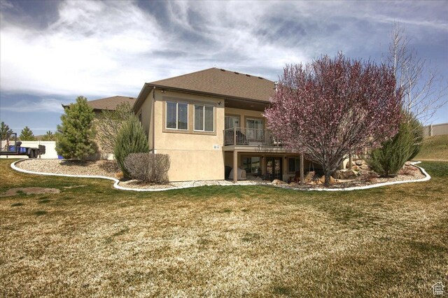 2630 E Riley Dr N, Eagle Mountain, UT 84005 - back of house with a lawn, a balcony, and stucco siding