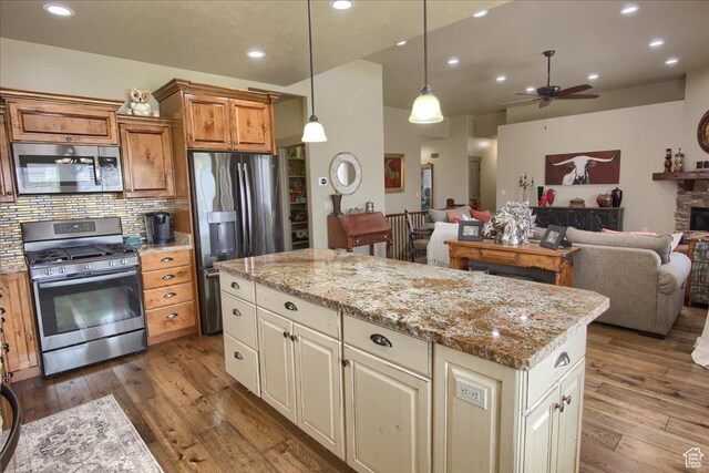 2630 E Riley Dr N, Eagle Mountain, UT 84005 - kitchen featuring stainless steel appliances, a ceiling fan, open floor plan, and dark wood finished floors