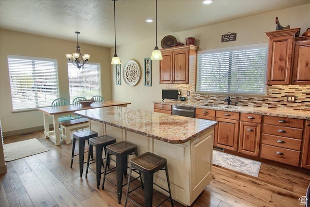 2630 E Riley Dr N, Eagle Mountain, UT 84005 - kitchen featuring dishwasher, a breakfast bar, a sink, and tasteful backsplash