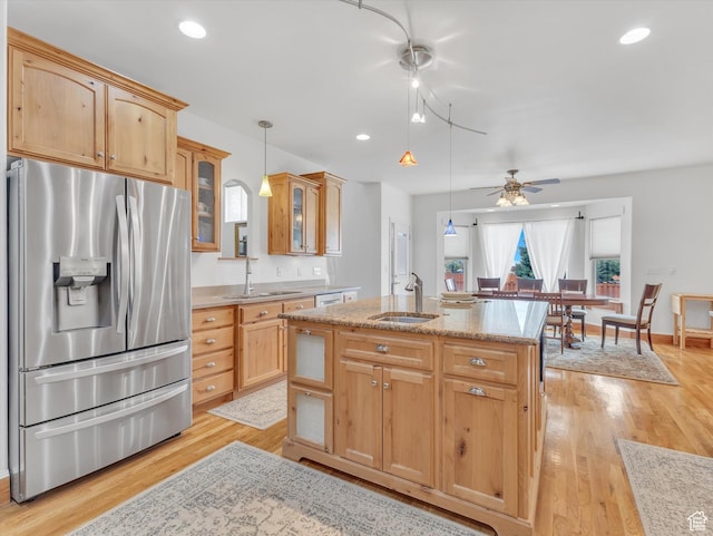 1055 N 1000 E, Mapleton, UT 84664 - kitchen featuring an island with sink, stainless steel fridge with ice dispenser, a sink, light wood-style floors, and glass insert cabinets