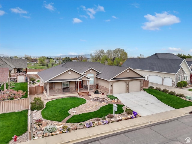 1055 N 1000 E, Mapleton, UT 84664 - ranch-style house with an attached garage, a porch, driveway, and a front lawn