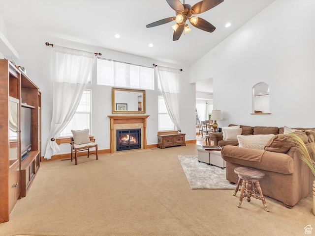 1055 N 1000 E, Mapleton, UT 84664 - carpeted living area with a fireplace with flush hearth, baseboards, a towering ceiling, recessed lighting, and ceiling fan
