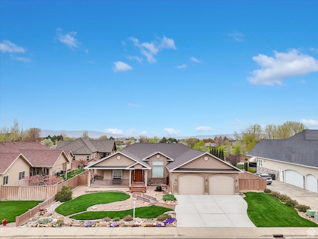 1055 N 1000 E, Mapleton, UT 84664 - view of front of house with a front lawn, driveway, covered porch, fence, and an attached garage