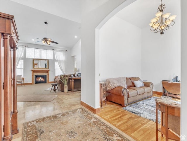 1055 N 1000 E, Mapleton, UT 84664 - living room with arched walkways, a glass covered fireplace, baseboards, recessed lighting, and ceiling fan with notable chandelier