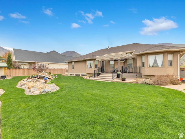 1055 N 1000 E, Mapleton, UT 84664 - rear view of property featuring fence, a pergola, stucco siding, a wooden deck, and a lawn
