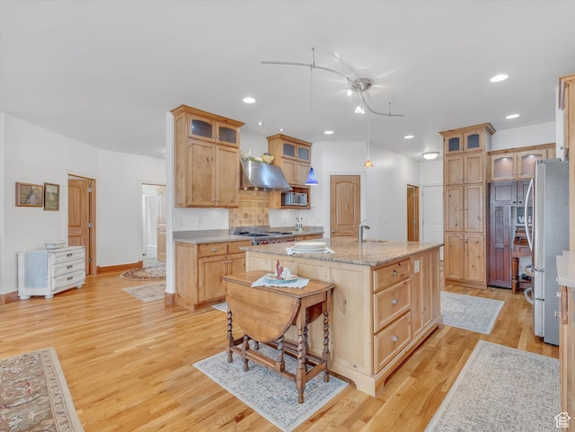 1055 N 1000 E, Mapleton, UT 84664 - kitchen featuring light wood-style flooring, a sink, a center island with sink, extractor fan, and appliances with stainless steel finishes