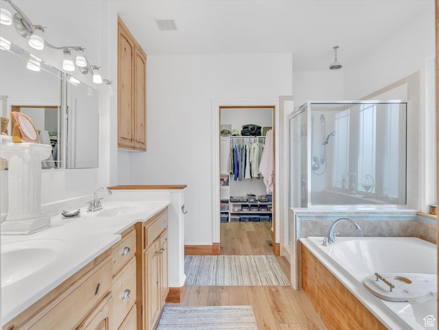 1055 N 1000 E, Mapleton, UT 84664 - bathroom with wood finished floors, visible vents, a sink, a garden tub, and a stall shower