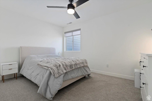 bedroom with baseboards, a ceiling fan, visible vents, and carpet