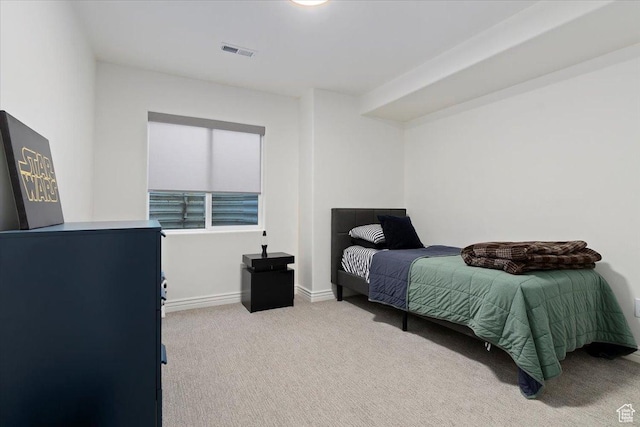 bedroom featuring visible vents, carpet flooring, and baseboards