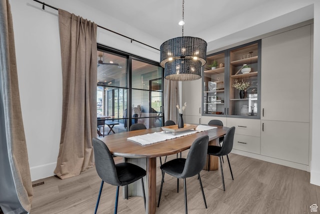 565 W Autumn Blaze, Woodland Hills, UT 84653 - dining area featuring baseboards, a notable chandelier, visible vents, and light wood-type flooring