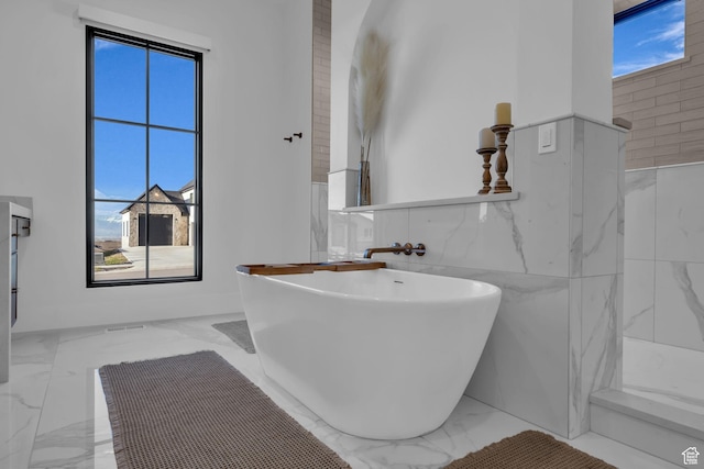 565 W Autumn Blaze, Woodland Hills, UT 84653 - full bath featuring marble finish floor, a freestanding bath, a wainscoted wall, and tile walls