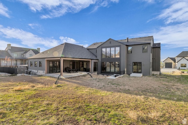 565 W Autumn Blaze, Woodland Hills, UT 84653 - rear view of property featuring a lawn, a patio, and board and batten siding