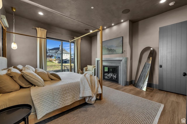 565 W Autumn Blaze, Woodland Hills, UT 84653 - bedroom with a glass covered fireplace, wood finished floors, and recessed lighting
