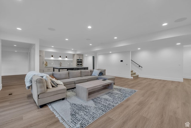565 W Autumn Blaze, Woodland Hills, UT 84653 - living room featuring light wood finished floors, baseboards, and stairway