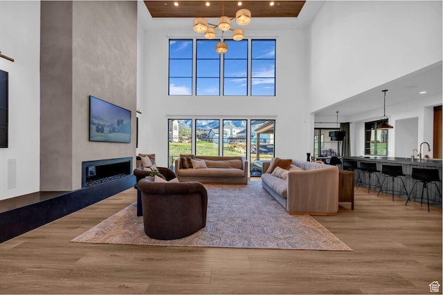 565 W Autumn Blaze, Woodland Hills, UT 84653 - living area featuring a towering ceiling, a glass covered fireplace, wood finished floors, and recessed lighting