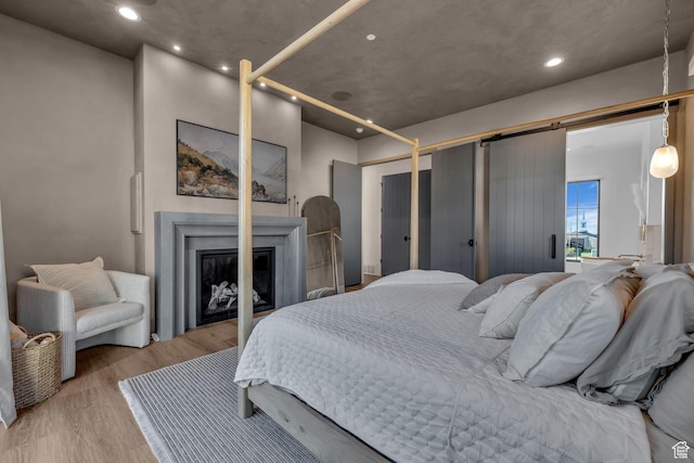 565 W Autumn Blaze, Woodland Hills, UT 84653 - bedroom featuring recessed lighting, a glass covered fireplace, and wood finished floors