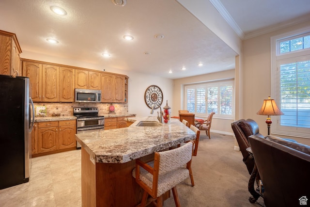 11855 S Cottage Side Way E, Draper, UT 84020 - kitchen with a kitchen breakfast bar, a sink, crown molding, tasteful backsplash, and appliances with stainless steel finishes